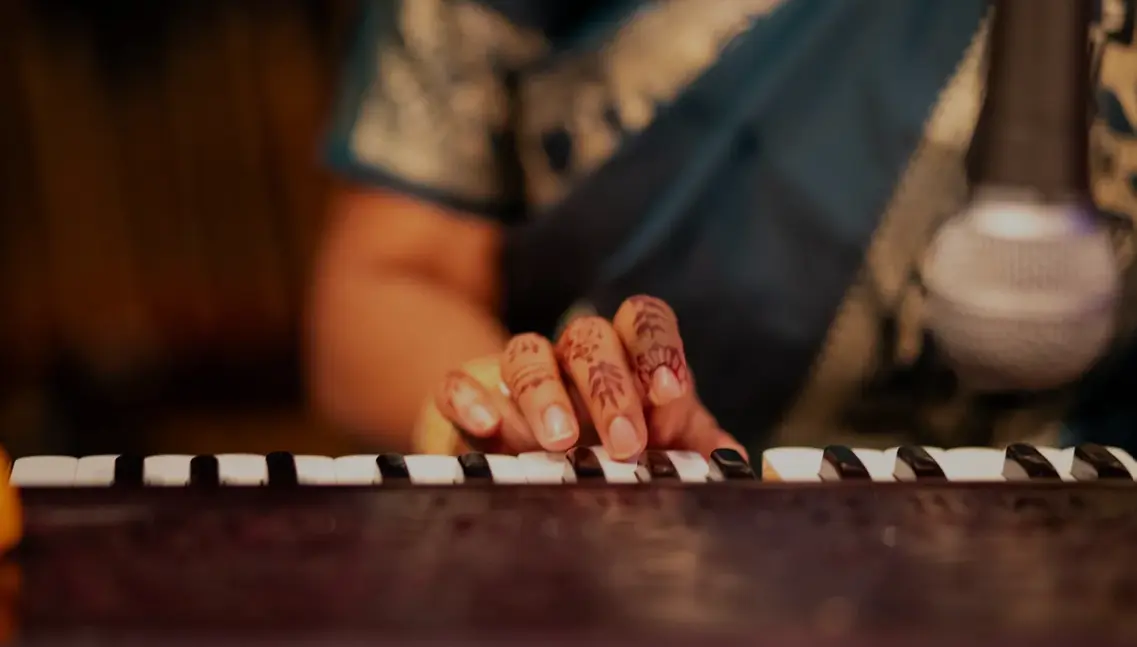 Close view of a Nootana musician performing on a string instrument