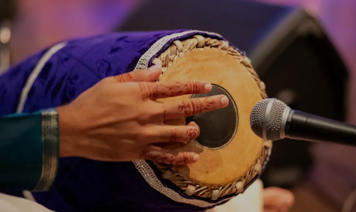 Close view of a Nootana musician playing mridangam